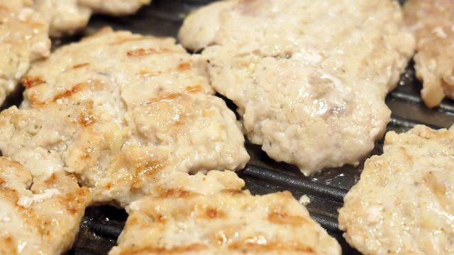 Meat cutlets are fried in a pan in a large amount of vegetable oil. Chops are cooked in a skillet in plenty of sunflower oil. Unhealthy Lifestyle, fried and high caloric food.