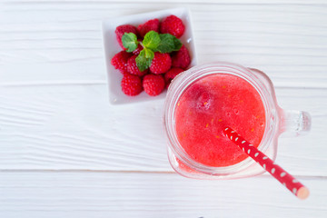 Raspberry smoothie red colorful fruit juice milkshake blend beverage healthy high protein the taste yummy In glass drink episode morning on white wood background from top view.