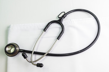 Medical stethoscope put on a white cloth on the table