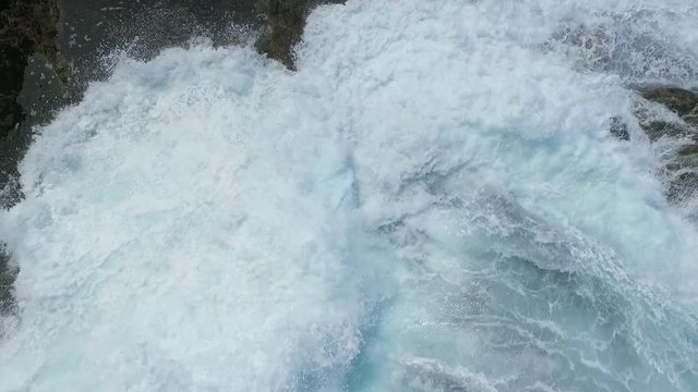 An amazing slow Motion aerial shot above Thor&rsquo;s Well as the violent yet, beautiful teal ocean waves rush over the jagged rocky Oregon coastline coving the entire rock shelf with saltwater flowing  