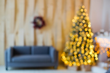 Christmas home room with Christmas tree and festive bokeh, blurred festive background