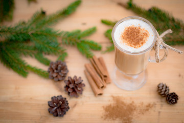 Chocolate Martini Cocktail or eggnog with cinnamon and chocolate in glass for Christmas on mahogany background. Homemade festive cocktail for winter holidays.Close up.