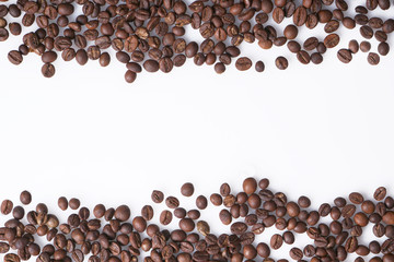 Arrangement of coffee beans on white with space for copy