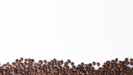 Arrangement of coffee beans on white with space for copy