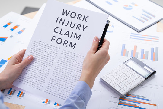 work injury claim form concept, documents on the desktop