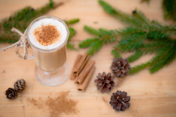 Chocolate Martini Cocktail or eggnog with cinnamon and chocolate in glass for Christmas on mahogany background. Homemade festive cocktail for winter holidays.Close up.