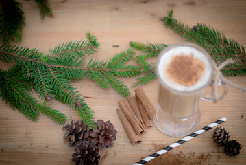 Chocolate Martini Cocktail or eggnog with cinnamon and chocolate in glass for Christmas on mahogany background. Homemade festive cocktail for winter holidays.Close up.