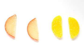 Naklejka na ściany i meble multi-colored marmalade in the form of slices of lemon and orange on a white background.