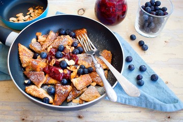 Traditional czech festive easter sweet dish trhanec or austrian Kaiserschmarrn with fresh blueberries, jam and roasted almonds.