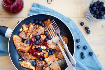 Traditional czech festive easter sweet dish trhanec or austrian Kaiserschmarrn with fresh blueberries, jam and roasted almonds.