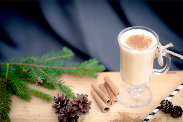 Chocolate Martini Cocktail or eggnog with cinnamon and chocolate in glass for Christmas on mahogany background. Homemade festive cocktail for winter holidays.Close up.