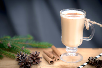 Chocolate Martini Cocktail or eggnog with cinnamon and chocolate in glass for Christmas on mahogany background. Homemade festive cocktail for winter holidays.Close up.