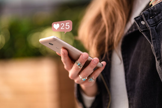 Stylish Casual Woman Using Smartphone For Likes On Social Networks While Walking Around The City. Phone Addiction And Be Online