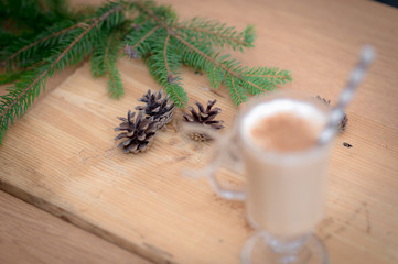 Chocolate Martini Cocktail or eggnog with cinnamon and chocolate in glass for Christmas on mahogany background. Homemade festive cocktail for winter holidays.Close up.