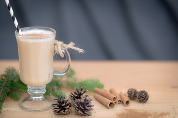 Chocolate Martini Cocktail or eggnog with cinnamon and chocolate in glass for Christmas on mahogany background. Homemade festive cocktail for winter holidays.Close up.