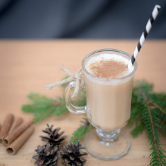 Chocolate Martini Cocktail or eggnog with cinnamon and chocolate in glass for Christmas on mahogany background. Homemade festive cocktail for winter holidays.Close up.