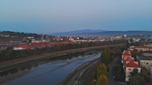 Panoramic view on a small city at sunrise above in the autumn over the Uzh River Uzhhorod Ukraine Europe