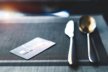 Credit card placed on dining table to pay for a restaurant bill. - 304330738