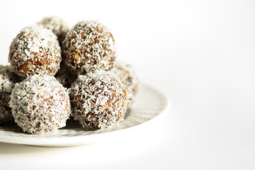 Energy balls on a white bowl on a white background