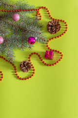 Blue spruce on a green background with Christmas toys