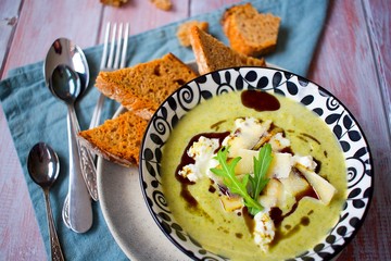Homemade brocolli cream soup with goat cheese and parmesan and toast