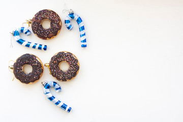 Donuts and candy canes on a white background, copy space
