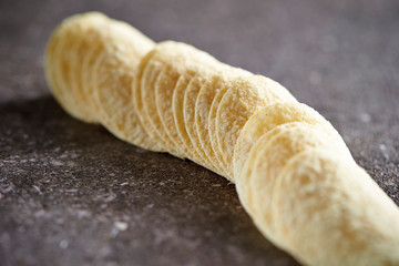 Potato chips on stone table 