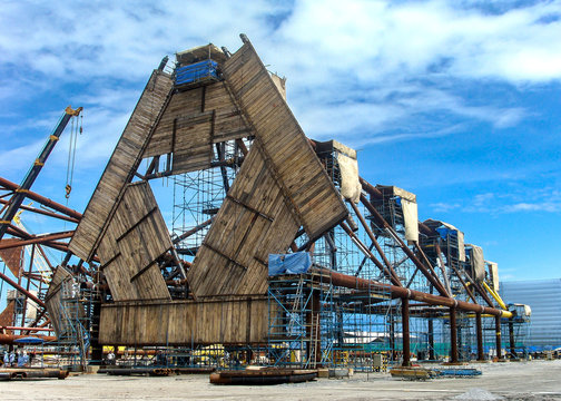 Oil rig platform during construction site in the harbor yard and workers preparing to move into the vessel to be installed in offshore locations.  - image Film grain effect