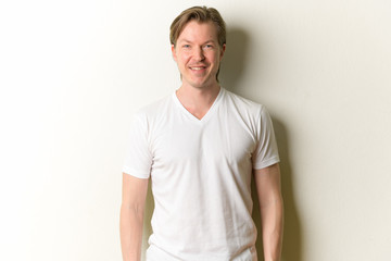 Fototapeta premium Portrait of happy young handsome man smiling