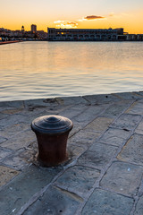 Naklejka premium Sunset from the Audace pier of Trieste. Colors of fire on the water. Italy