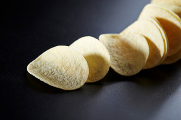 Potato chip on black background 