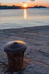Naklejka premium Sunset from the Audace pier of Trieste. Colors of fire on the water. Italy