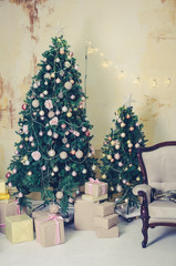 Beautiful holdiay decorated room with Christmas tree with presents under it