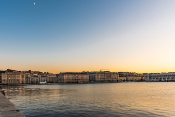Fototapeta premium Sunset from the Audace pier of Trieste. Colors of fire on the water. Italy