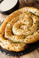 Traditional Balkan pie borek (burek) with feta served with yogurt close-up on the table. vertical