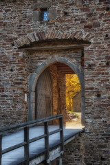 Castle gate through which autumn light shines