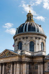 Fototapeta na wymiar Dome of The Institut de France at the bank of Seine River, Paris. A French learned society, grouping five academies, the most famous of which is the Academie francaise