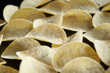 Potato chip on black background 