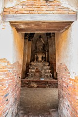 Fototapeta na wymiar Buddha statues inside Wat Chaiwatthanaram temple in Ayutthaya Historical Park, Thailand