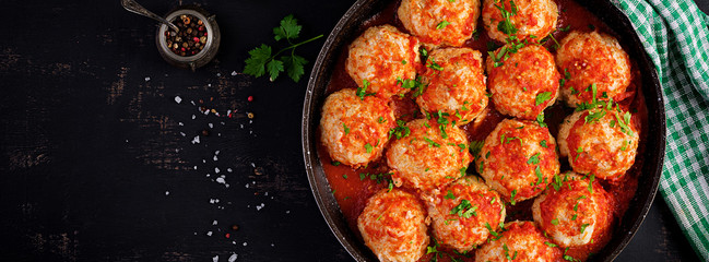 Meatballs in sweet and sour tomato sauce. Top view, banner