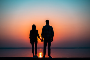 The couple against the beautiful sunset sky