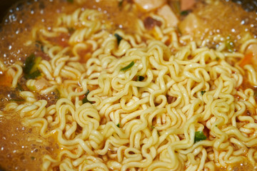 Cooking instant ramen noodle in pot 