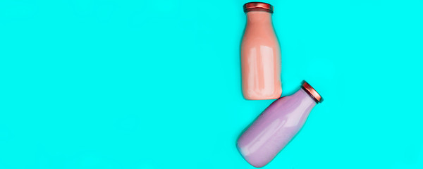 Fruit and vegetables smoothies in glass bottles on blue background. Fresh organic Smoothie ingredients. Superfoods and health or detox diet food concept.