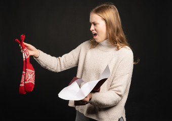 angry young woman holds up her gift socks