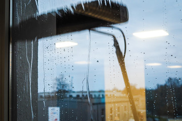 Window cleaning using telescopic water brush and wash system. Commercial window cleaning from the...