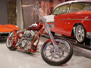 Peel and stick wall murals customized motorcycle with v-twin cylinder motorcycle engine with chrome coating. Orange motorcycle frame with white flames.