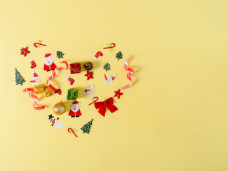 Christmas objects with heart shape on yellow background.