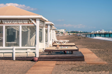 Beach tents. Beach front dual leather relax chairs near the beach tent facing the sea.