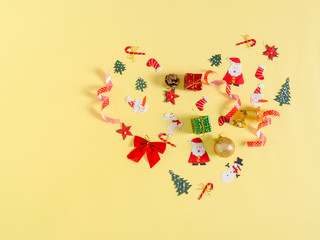 Christmas objects with heart shape on yellow background.