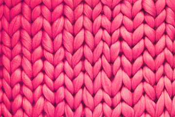 Texture of pink wool big knit blanket. Large knitting. Plaid merino wool. Top view